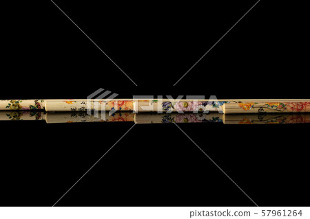 Asian chopsticks isolated on black glass Asian chopsticks isolated on black glass 57961264