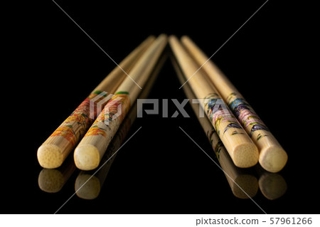 Asian chopsticks isolated on black glass Asian chopsticks isolated on black glass 57961266