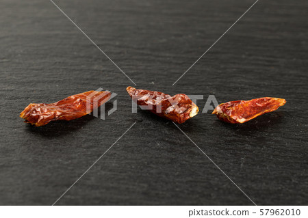 Dry red pepperoncino pepper on grey stone Dry red pepperoncino pepper on grey stone 57962010