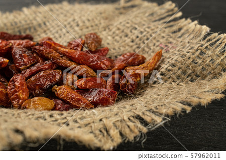 Dry red pepperoncino pepper on grey stone Dry red pepperoncino pepper on grey stone 57962011