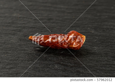 Dry red pepperoncino pepper on grey stone Dry red pepperoncino pepper on grey stone 57962012