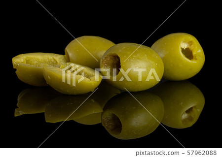 Pitted green olive isolated on black glass Pitted green olive isolated on black glass 57962088