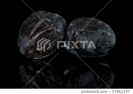 Drying dark plum isolated on black glass 57962147