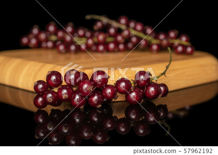 Fresh dark redcurrant isolated on black glass 57962192