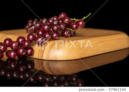 Fresh dark redcurrant isolated on black glass Fresh dark redcurrant isolated on black glass 57962194