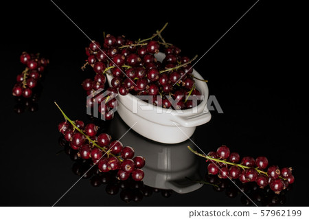 Fresh dark redcurrant isolated on black glass 57962199