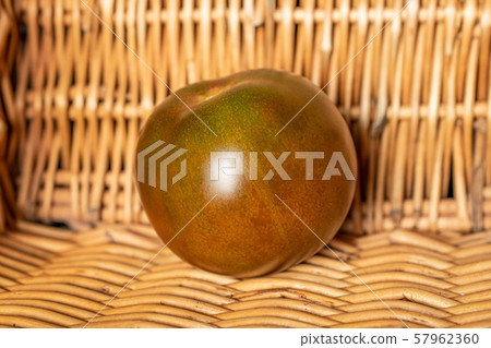 Fresh green red tomato with braided rattan Fresh green red tomato with braided rattan 57962360