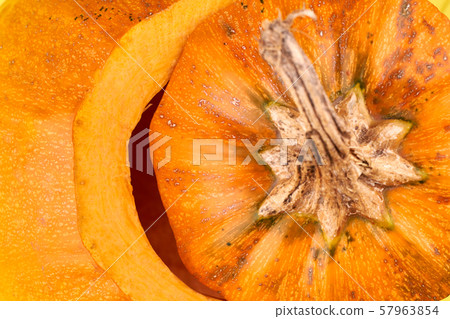 Macro of a ripe orange pumpkin stem. 57963854