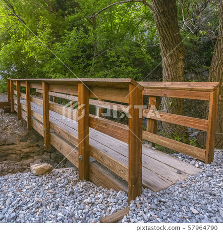 Wooden bridge over rocky stream in Provo forest 57964790