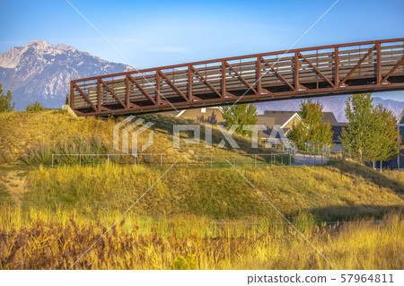 Winding path and bridge against mountain and sky 57964811