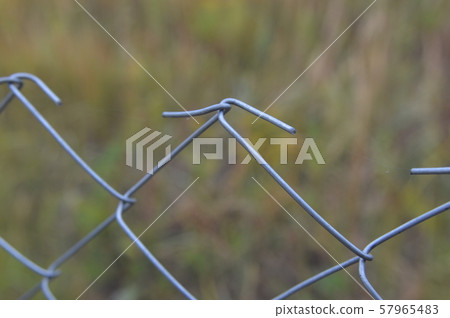 Barbed wire stretched on a fence for security 57965483