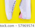 White sneakers on yellow background 57969574
