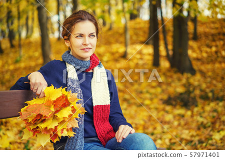 Portrait of young beautiful woman in autumn park Portrait of young beautiful woman in autumn park 57971401