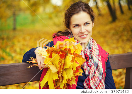 Portrait of young beautiful woman in autumn park Portrait of young beautiful woman in autumn park 57971483