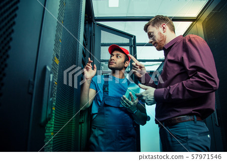 Nice smart people standing together near the server 57971546