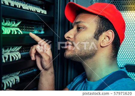 Pleasant smart man pointing with his finger Pleasant smart man pointing with his finger 57971620