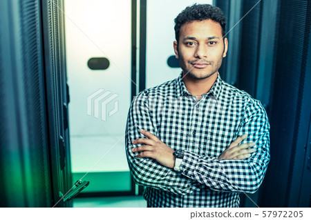Smart intelligent man standing in the server room Smart intelligent man standing in the server room 57972205