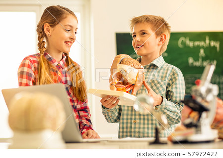Cheerful blonde boy talking about human anatomy Cheerful blonde boy talking about human anatomy 57972422