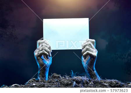 Picture of zombie hands with empty sheet of paper sticking out of grave 57973623