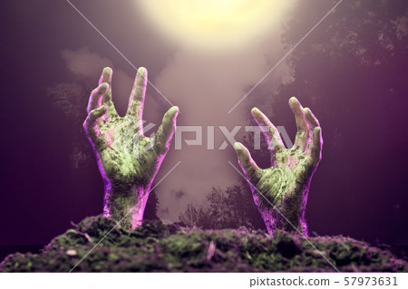Photo of two zombie hands sticking out of grave. 57973631