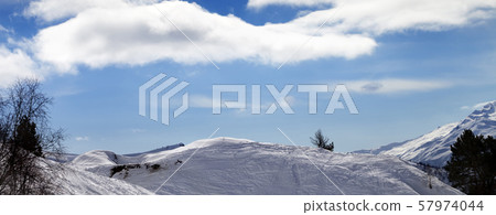 Off-piste slope with traces from skis and Off-piste slope with traces from skis and 57974044