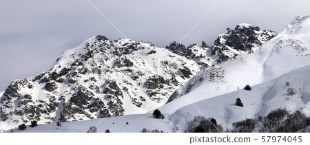 Snow sunlight mountain and cloudy sky at gray Snow sunlight mountain and cloudy sky at gray 57974045