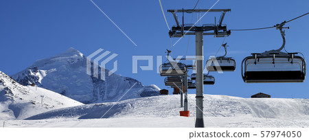 Chair lift in snowy mountains at nice sunny day 57974050