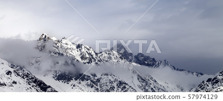 Sunlight mountains and gray cloudy sky Sunlight mountains and gray cloudy sky 57974129