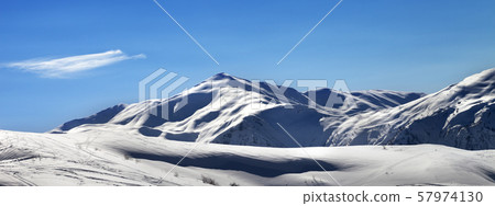 Off-piste ski slope in sunny evening Off-piste ski slope in sunny evening 57974130