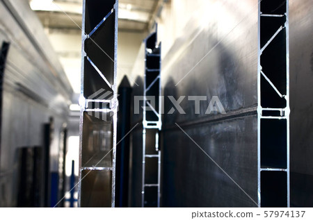 Aluminum profile in the production hall of an industrial plant, close up.  57974137