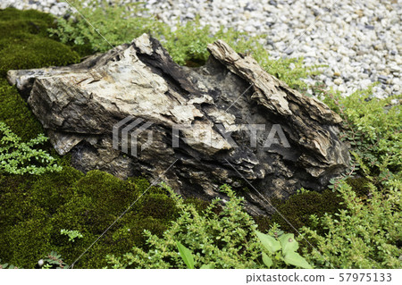 Natural stone landscaping in home garden 57975133