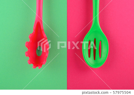 bright kitchen utensils on red and green background, creative idea bright kitchen utensils on red and green background, creative idea 57975504