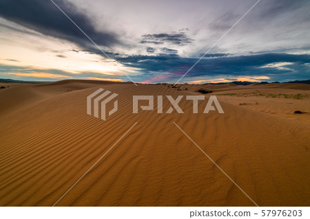 Sunset over the sand dunes in the desert 57976203