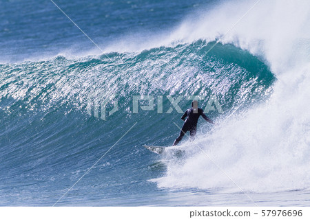 Surfer Surfing Rides Cold Wave 57976696