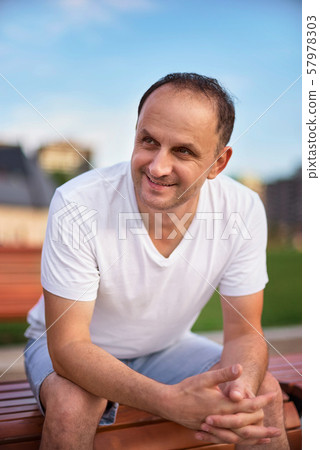 Handsome middle age man smiling looking to the Handsome middle age man smiling looking to the 57978303