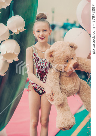 Beautiful little gymnast training on the carpet and ready for competitions 57978897