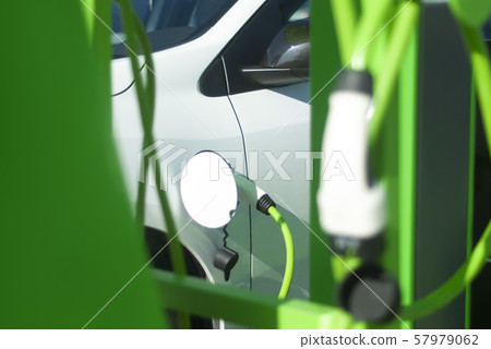 Electric car battery charging on charge station. Eco-friendly new generation gas station. 57979062