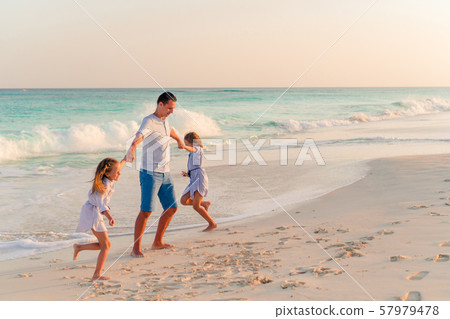 Family walking on white tropical beach on caribbean island 57979478