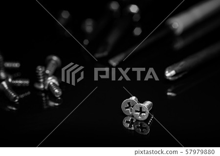 Black screws on a dark background 57979880