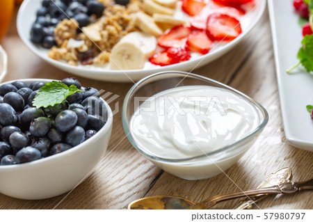 Yogurt in a glass  bowl with healthy breakfast on 57980797