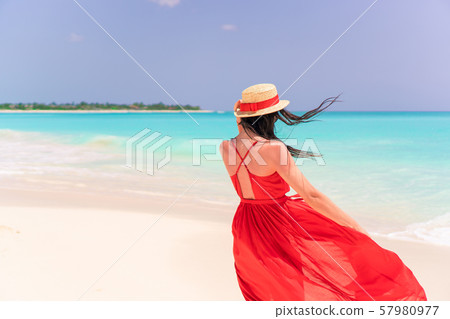Young girl in beautiful red dress background the sea Young girl in beautiful red dress background the sea 57980977