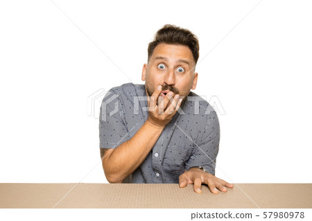 Shocked man opening the biggest postal package 57980978