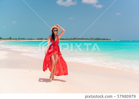Young girl in beautiful red dress background the sea Young girl in beautiful red dress background the sea 57980979