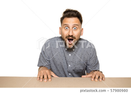 Shocked man opening the biggest postal package Shocked man opening the biggest postal package 57980980