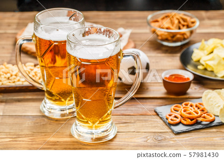 Appetizers and beer on the table for watch the football match. Appetizers and beer on the table for watch the football match. 57981430