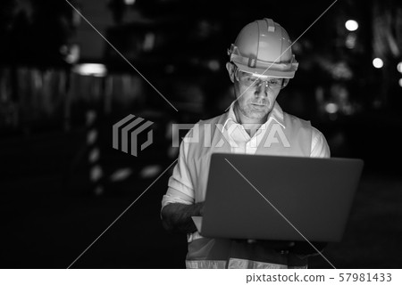 Construction worker at the construction site using laptop computer Construction worker at the construction site using laptop computer 57981433