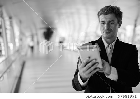 Businessman relaxing at the footbridge in Bangkok, Thailand 57981951