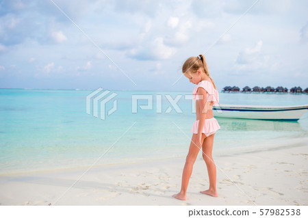 Adorable little girl during beach vacation having fun 57982538