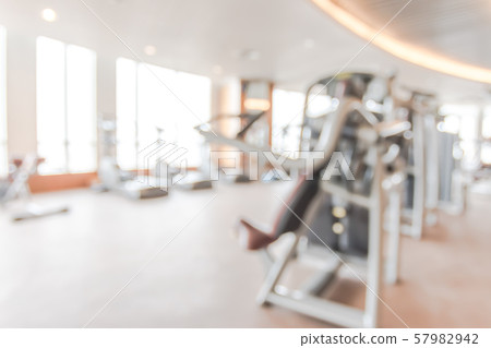 Blur gym background fitness center or health club with blurry sports exercise equipment for aerobic workout and bodybuilding 57982942