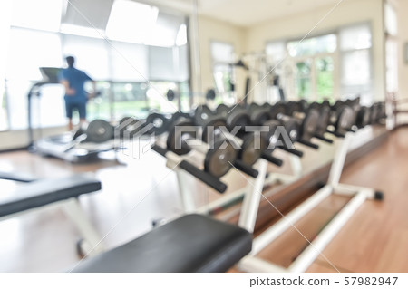 Blur gym background fitness center or health club with blurry sports exercise equipment for aerobic workout and bodybuilding 57982947